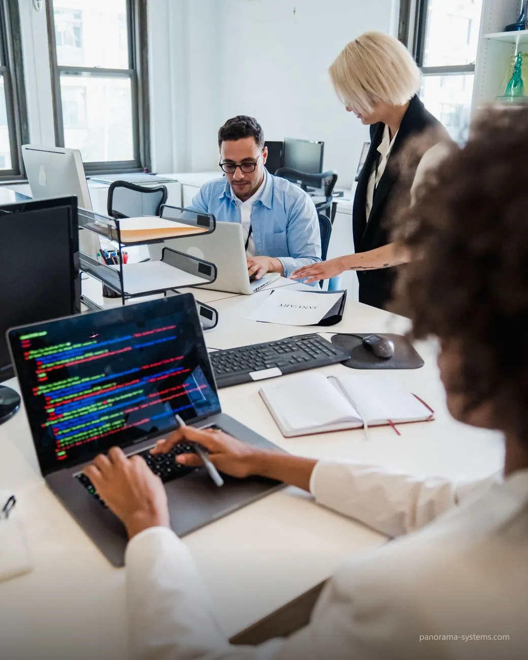 A software team working together at their laptops